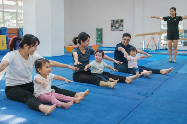 Parents and toddlers taking part in a Gymtots group class.